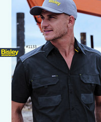 Work Shirt #1133 Bisley Work Shirt With Logo Service. Available XS-6XL in Black, Khaki and Charcoal. Mechanical Stretch fabric for extra comfort. Reflective cord piping across the front shoulders and across the back. Anti static carbon yarn in polyester patches for added static control.100% Cotton Twill Mechanical Stretch, two mitred pen pockets and pen division, hidden phone pouch on left chest pocket. Corporate Sales FreeCall 1800 654 990